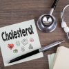 cholesterol, workplace of a doctor. stethoscope on wooden desk background