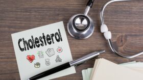 cholesterol, workplace of a doctor. stethoscope on wooden desk background