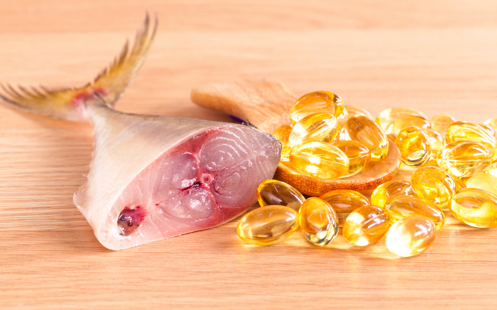 cod,liver,oil,capsules,on,wooden,panel,.